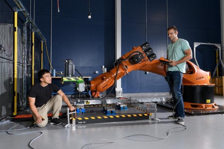 Toni Cvitanic (right) with Kuka industrial robot with Vinh Nguyen